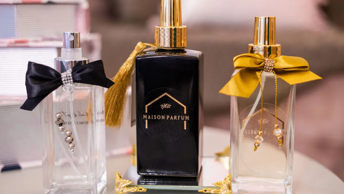 Flacon de Blanche Bête sur fond crème, entouré de fleurs blanches et d'un voile musqué.